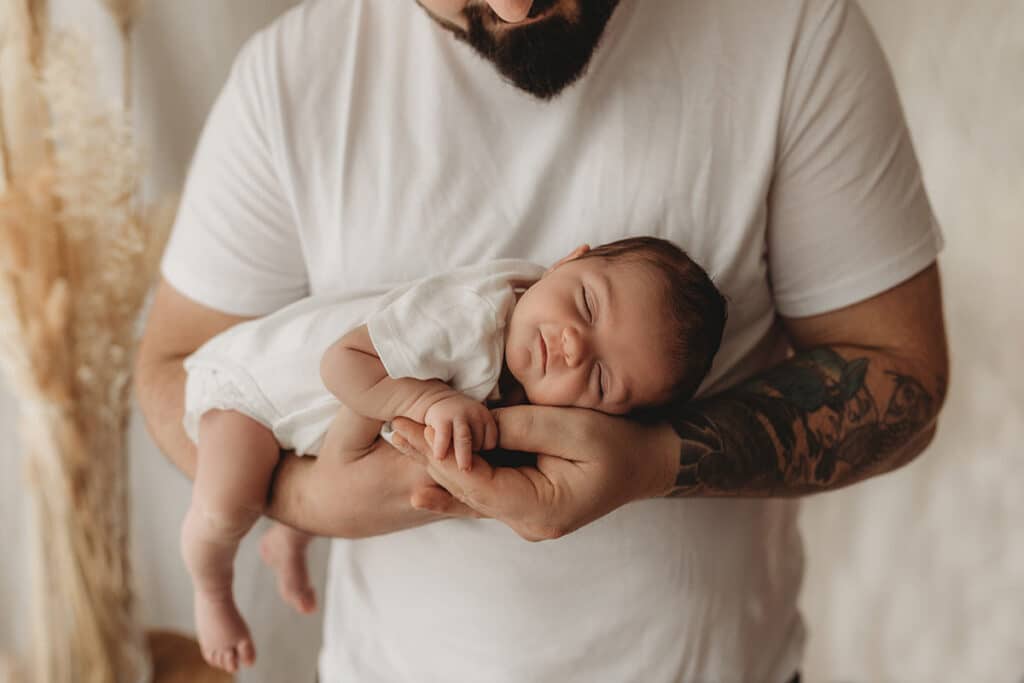 neugeborenenshooting baby auf papas arm